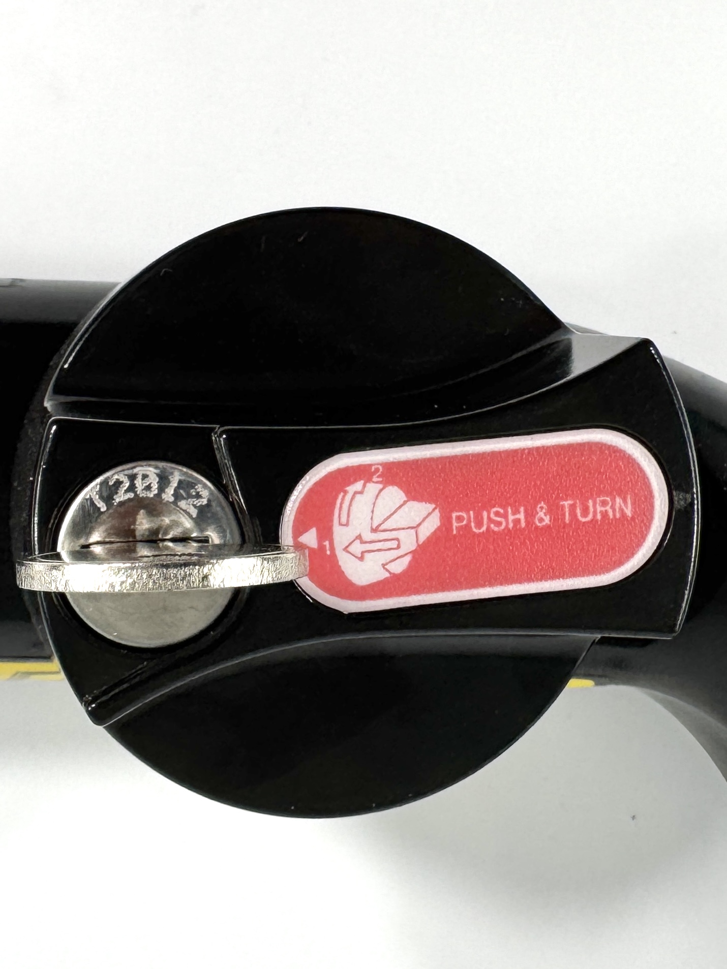 Close-up of the lock and push-and-turn release mechanism on an ORIS AK4 detachable towbar with inserted key.