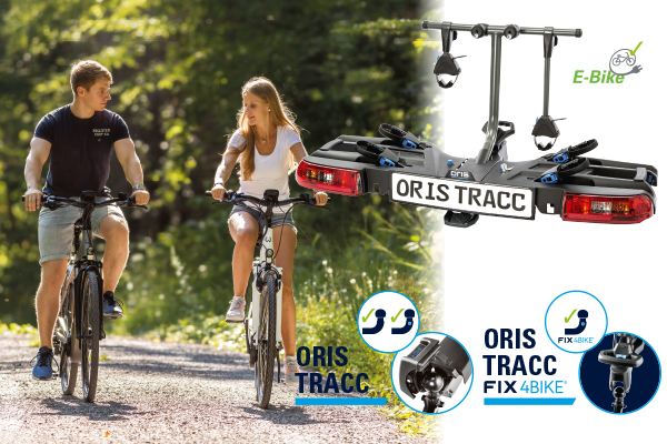 Couple riding e-bikes on a forest path beside a product illustration of the ORIS TRACC bike carrier with E-bike and FIX4BIKE compatibility highlights on a white background.