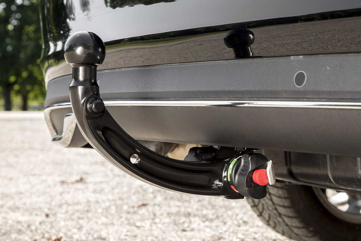 Close-up of an installed ORIS vertically detachable towbar with visible locking mechanism beneath a vehicle rear bumper.