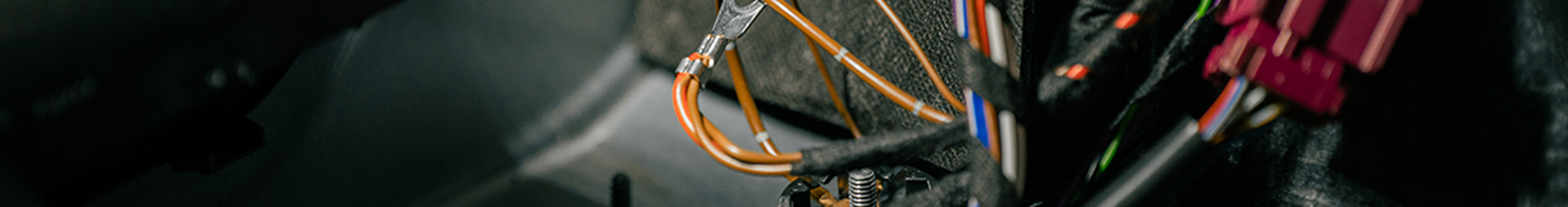 Close-up of vehicle-specific wiring and electrical connectors used in an ORIS DUO complete towbar retrofit kit.