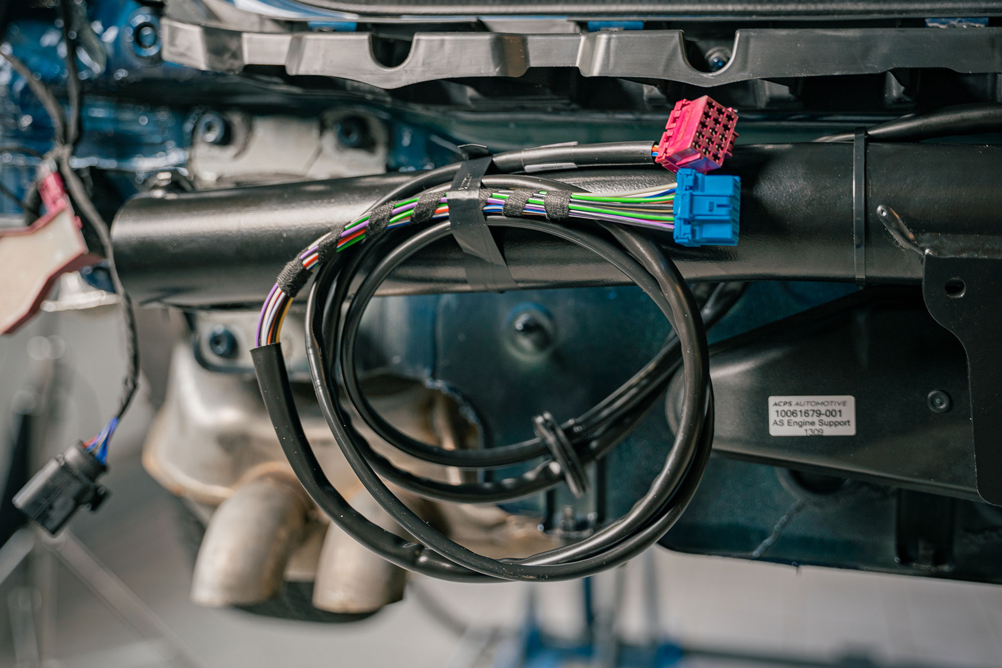 DUO complete set wiring harness mounted behind the rear bumper of a vehicle during ORIS towbar installation.