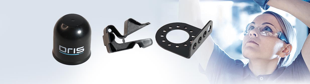 ORIS towbar accessories including protective cap, socket holder and mounting bracket with technician working in the background.