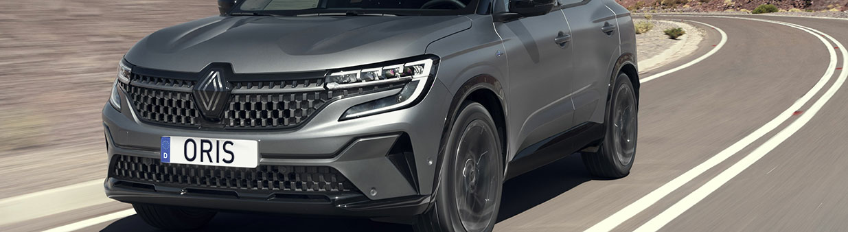 Grey Renault SUV driving on a winding road as a visual for ORIS eMobility and electric vehicle towing solutions.